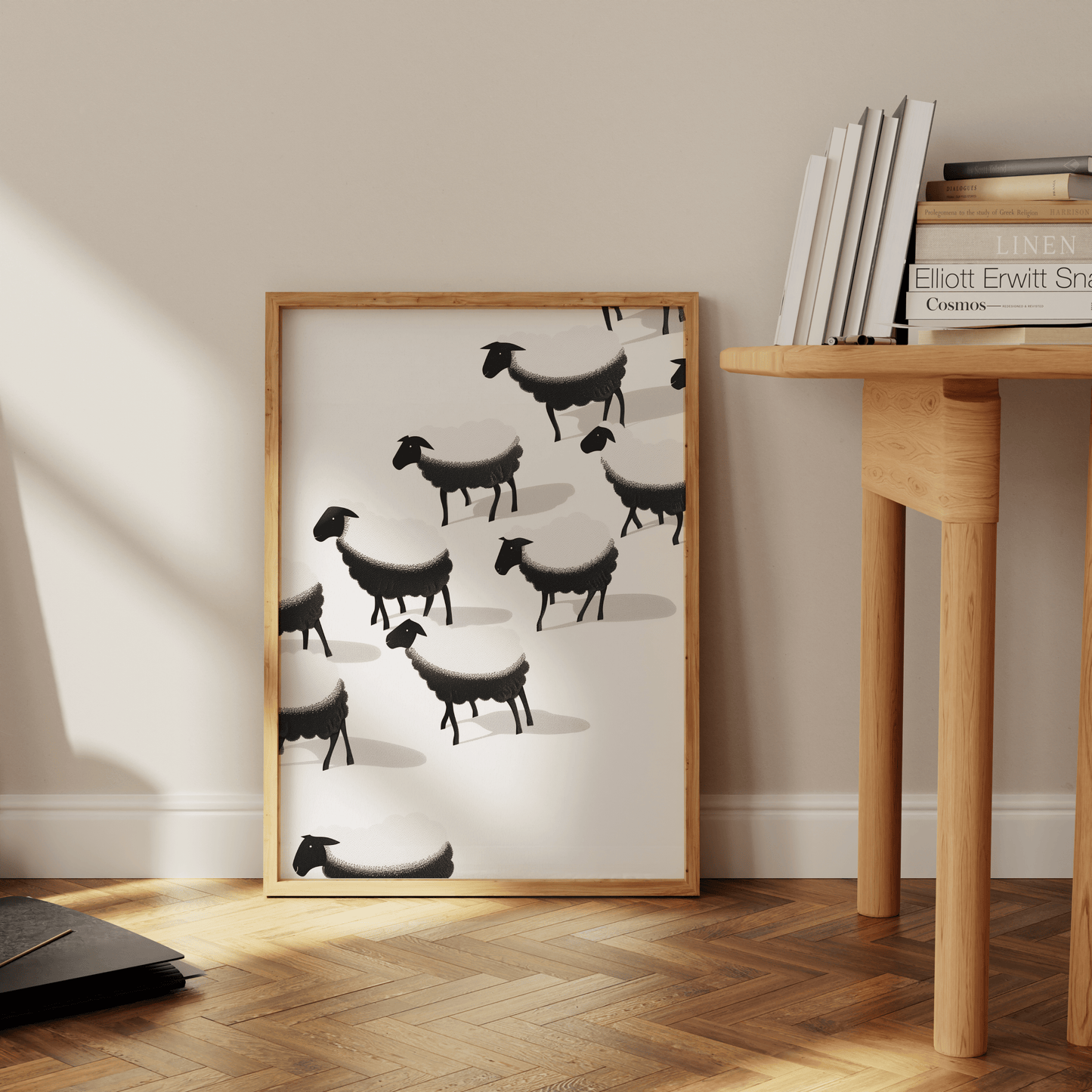 Framed painting of a herd of black and white sheep, leaning against the office wall - Paw Prints