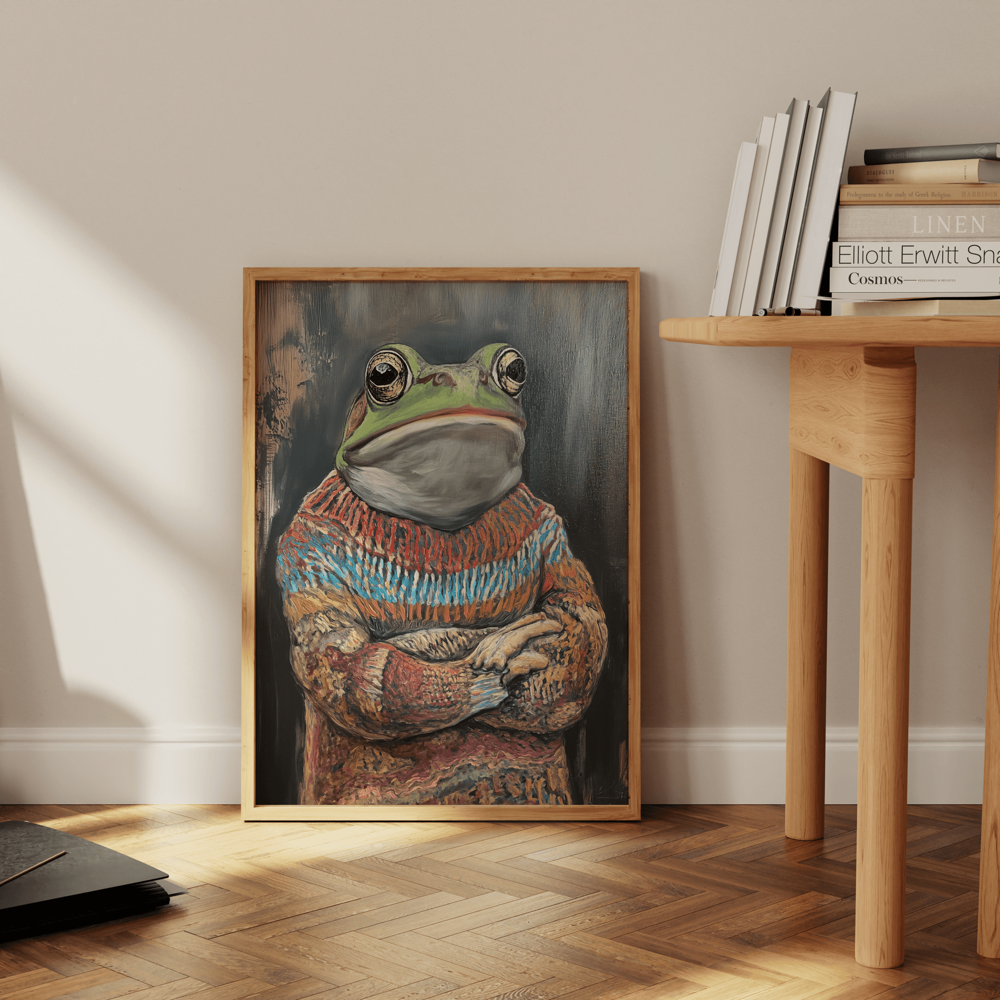 Framed painting of a grumpy frog wearing an ugly Christmas Sweater, leaning against the office wall - Paw Prints